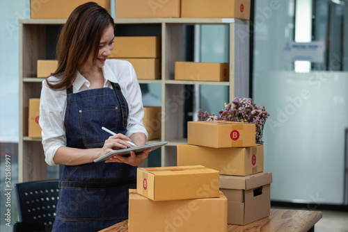 Online sales woman business owner Receive orders and deliver products with boxes to customers. Online SME business concept.
