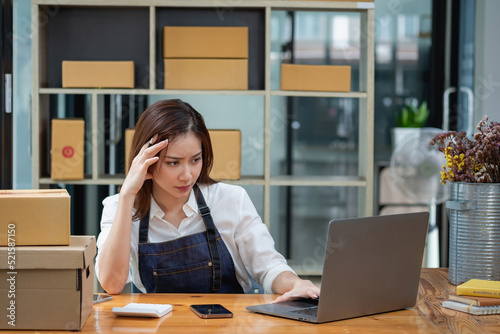 Asian businesswoman worried about unordered online sales photo