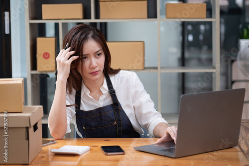 Asian businesswoman worried about unordered online sales photo