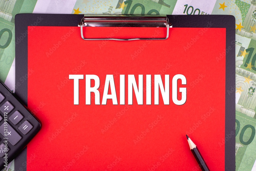 TRAINING - word on the background of money, a notepad and a pencil with a calculator. Business concept (copy space). TRAINING - word on the background of money, a notepad and a pencil with a calculator. Business concept (copy space).