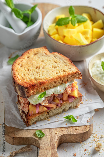 Delicious and sweet sandwich with exotic fruits, chicken and herbs.