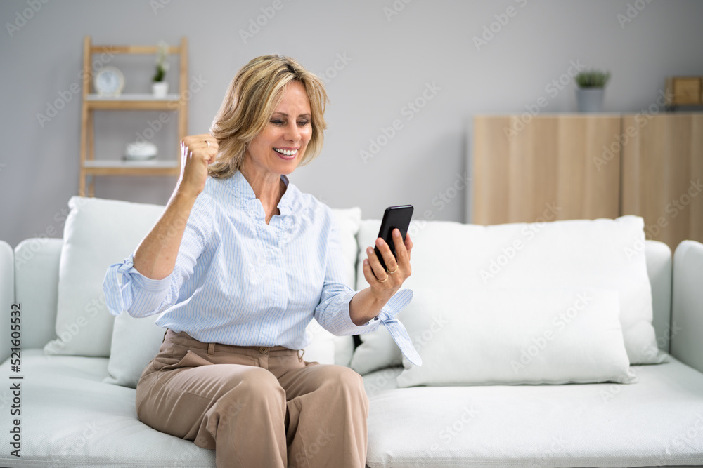 Amused Elder Woman Celebrating With Cellphone Amused Elder Woman Celebrating With Cellphone