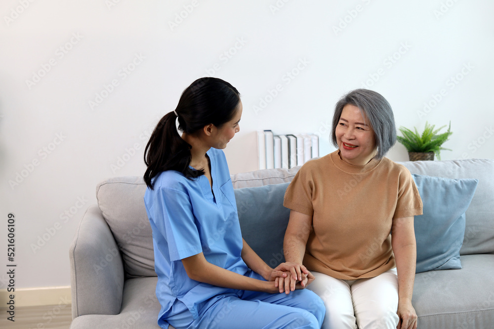 A young nurse is examining the body and asking for symptoms from an elderly patient. A young nurse is examining the body and asking for symptoms from an elderly patient.