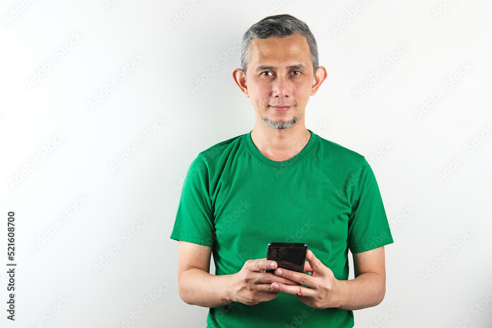 Portrait of Asian Man with mobile phone in hands, typing message, using social media.
Portrait of Asian Man with mobile phone in hands, typing message, using social media.