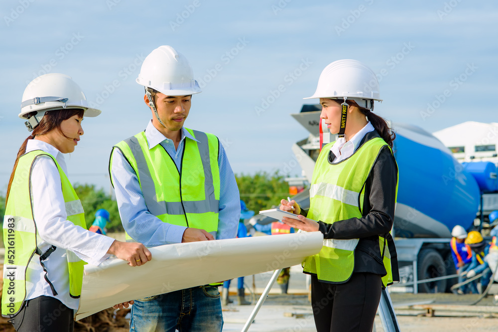 Engineer construction standing see plan paper at the construction site. Engineer construction standing see plan paper at the construction site.