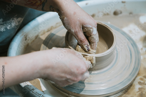 work in a pottery workshop. close-up of hands and potter s wheel