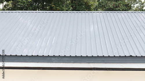 The gray metal sheet roof comprises the top floor of the building.