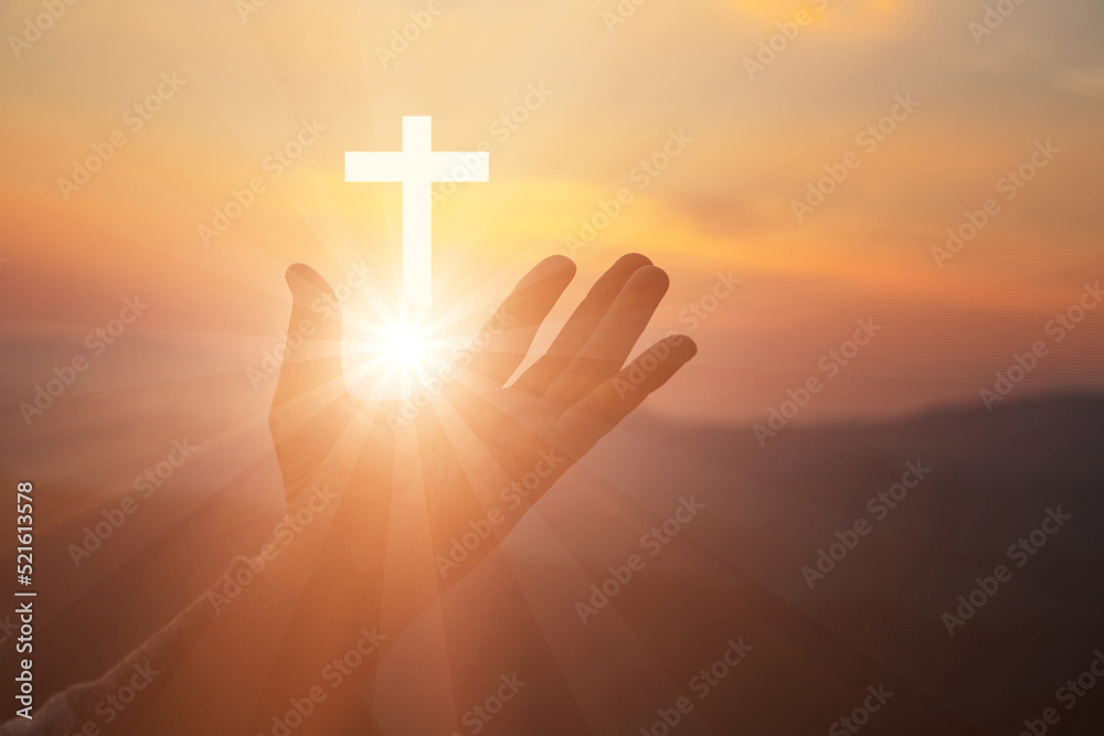 Silhouette of human hands palm up praying and worship of cross, eucharist therapy bless god helping, belief, forgiveness, freedom, hope and faith, christian religion concept on sunset background.