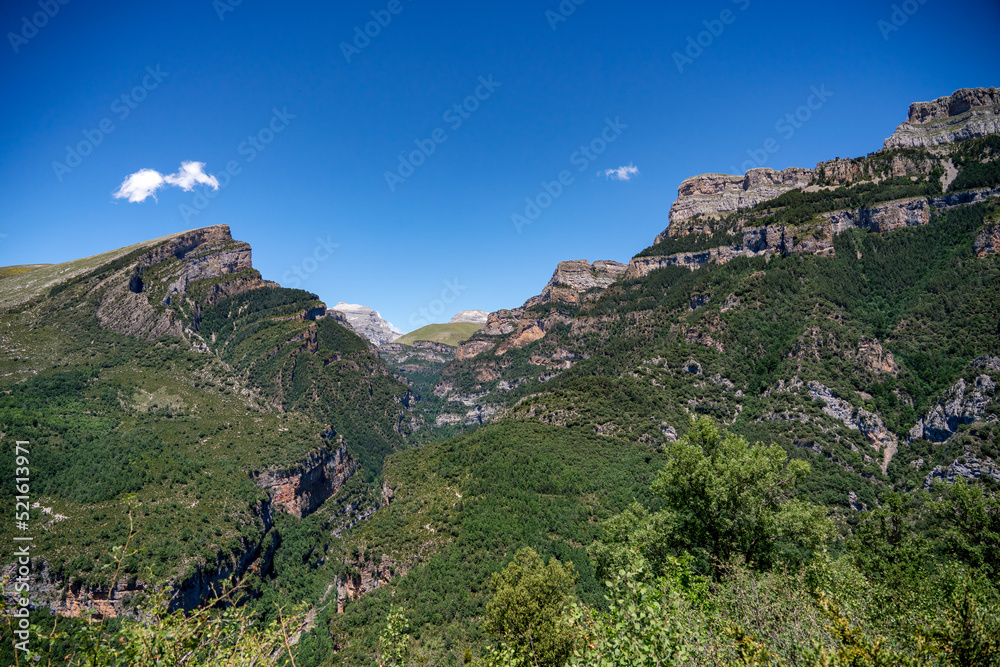 forested canyon and gorge in a mountain range, the Anisclo Canyon, Ordesa National Park, Aragon Spain, blue sky