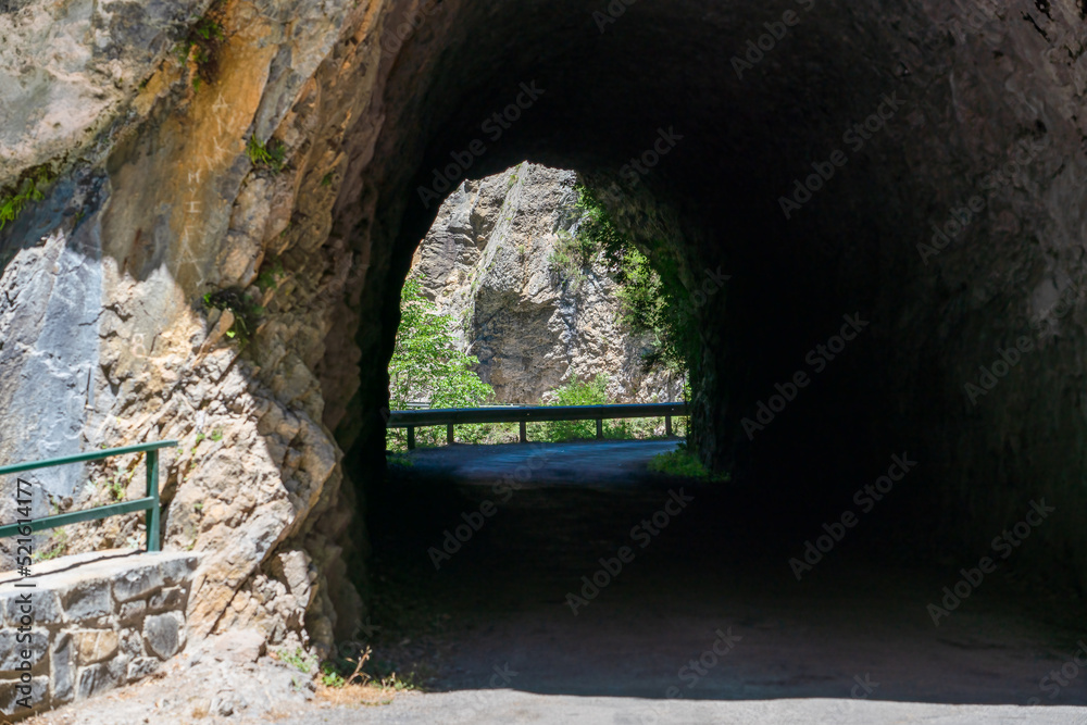 tunnel bored through rock for a road, the Anisclo Canyon, Ordesa National Park, Aragon Spain, blue sky