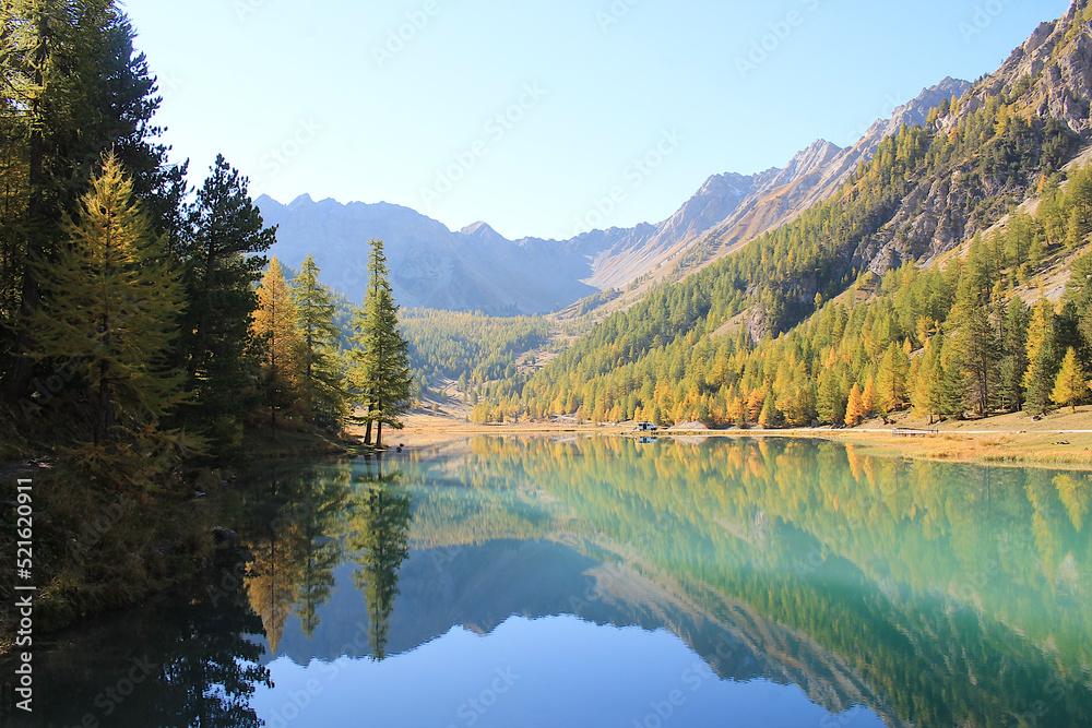 The wonderful Orceyrette Lake in autumn with larch tree forest, Briancon, hautes alpes, french alps
