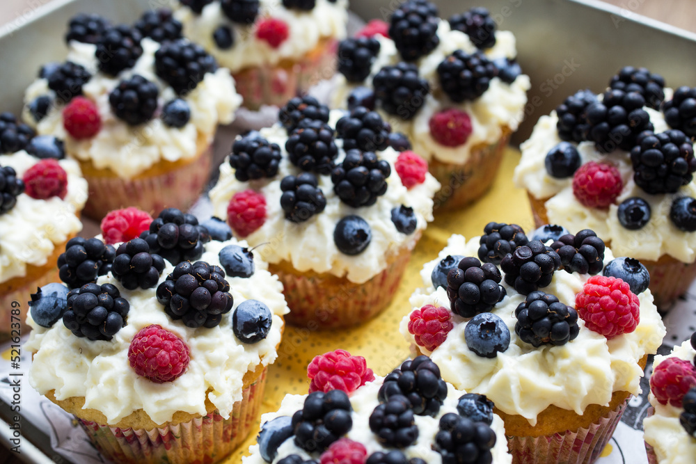 Homemade cupcakes decorated white cream and wild berries, delicious and fresh, Homemade cupcakes decorated white cream and wild berries, delicious and fresh,
