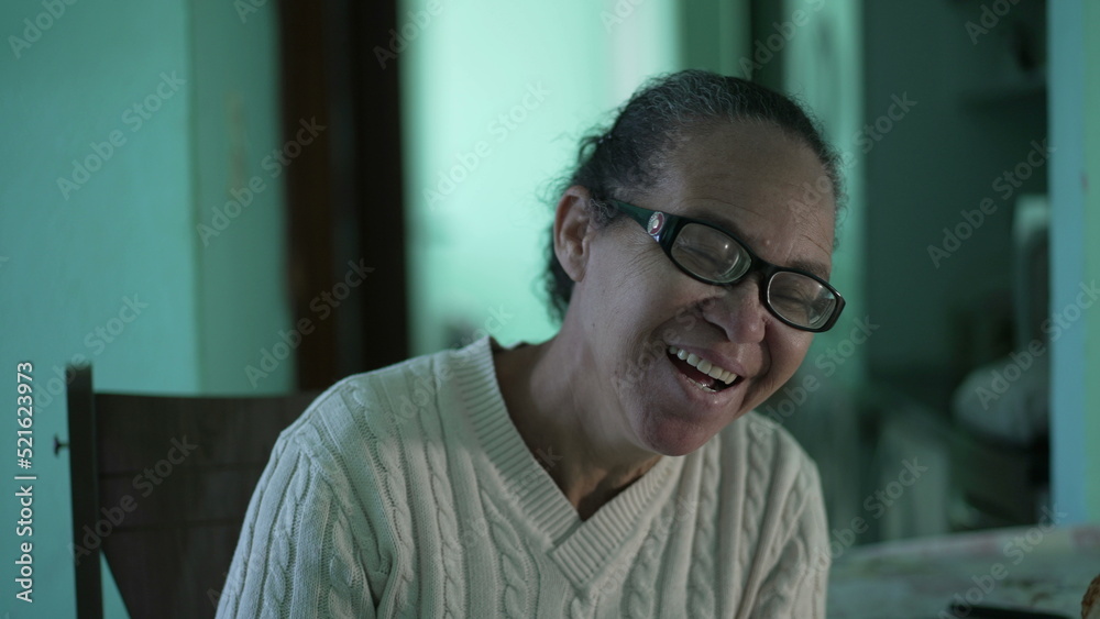 A hispanic senior woman laughing and smiling. One Casual older black woman laughs A hispanic senior woman laughing and smiling. One Casual older black woman laughs