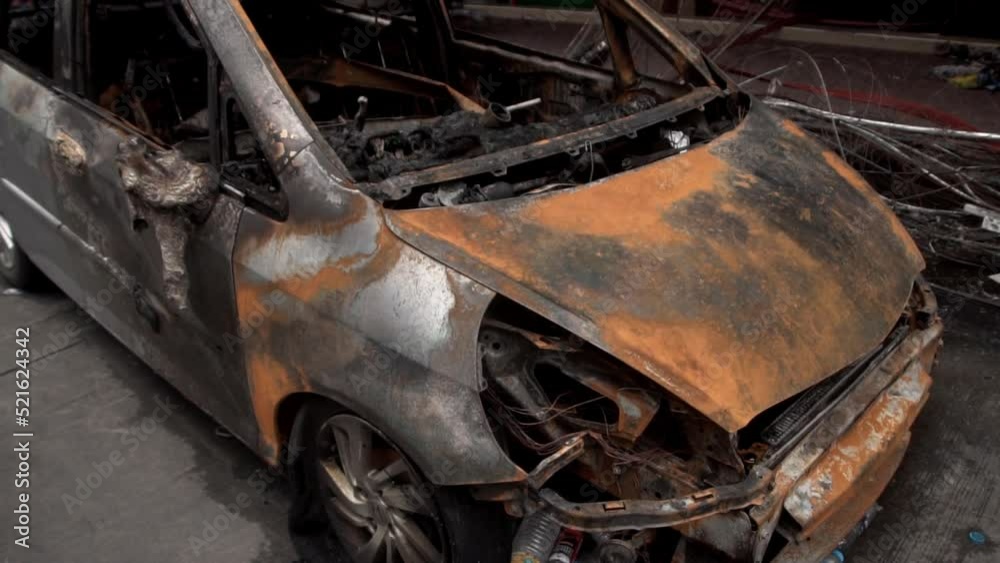 Damaged car and building after the fire . Burnt down buliding in city. Damaged car and building after the fire . Burnt down buliding in city.