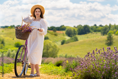 Fotografija Country life fashion concept with woman and a bicycle
