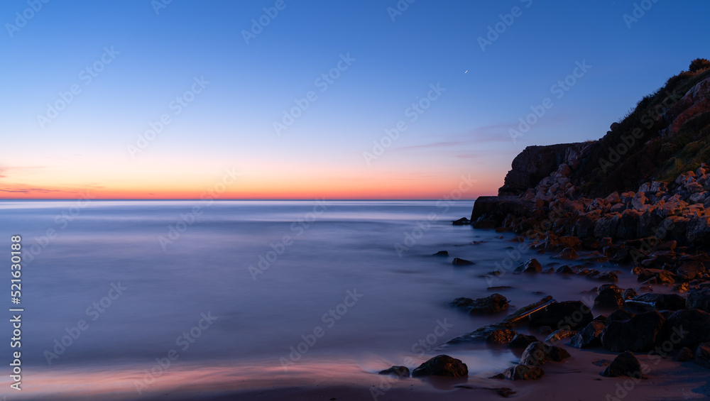 rocks in the calm sea dawning minimalism