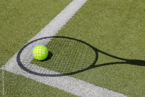 shadow of a tennis racket on the green floor, tennisball on the floor, with white line, no person