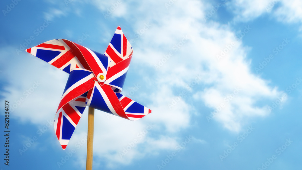 Pinwheel with UK flag theme against blue sky.