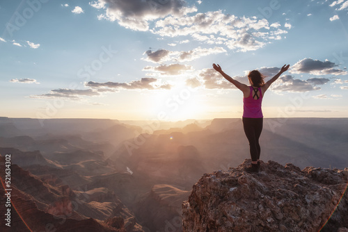 Adventurous Traveler standing on Desert Rocky Mountain American Landscape. Cloudy Sunny Sky. Grand Canyon National Park, Arizona, United States. Adventure Travel