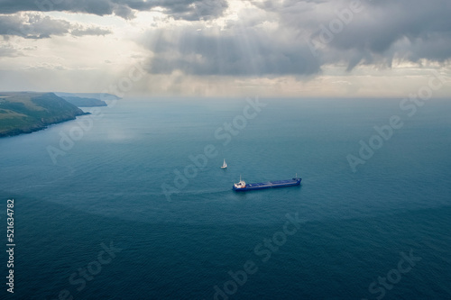 Aerial view of cargo ship and yacht at Fowey harbour, Cornwall, United Kingdom. photo