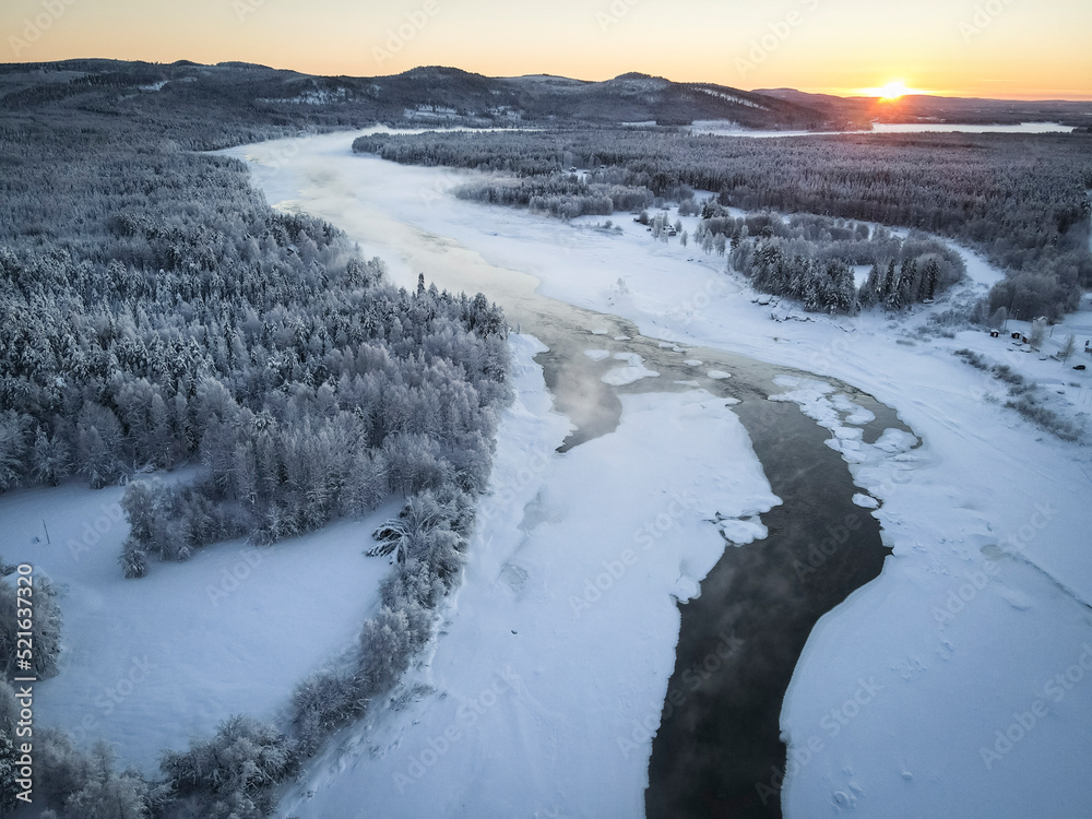 Aerial view of Kattilakoski Rapids in Winter during sunset in Norrbotten, Sweden. Aerial view of Kattilakoski Rapids in Winter during sunset in Norrbotten, Sweden.