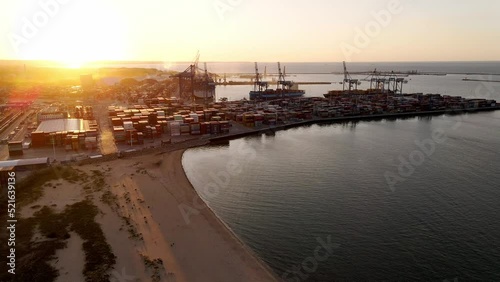 Wallpaper Mural Aerial view of an industrial port with cargo containers at sunset. Sun setting at the sea. Camera flying over port with shipping containers. High quality 4k footage Torontodigital.ca