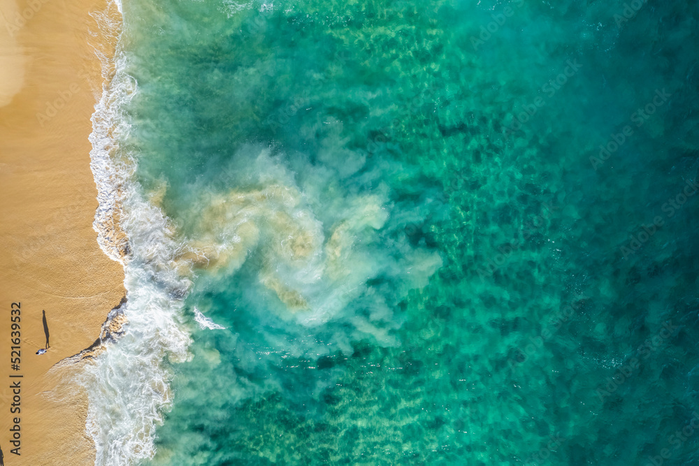Aerial view of a person on the beach at Playa de los Amantes, Cabo San Lucas, Baja California, Mexico. Aerial view of a person on the beach at Playa de los Amantes, Cabo San Lucas, Baja California, Mexico.