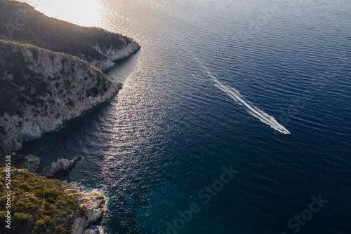 Aerial view of a motorboat sailing along the coastline in Marciana Marina, Elba Island, Italy. photo