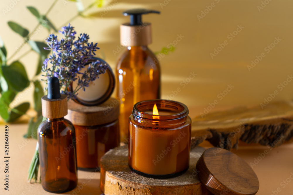 Soy candles in a glass jar. Aromatherapy. Burning candle and lavender. Wooden lid for jars. Beige background. Comfort and relaxation. Handmade. Home decor.