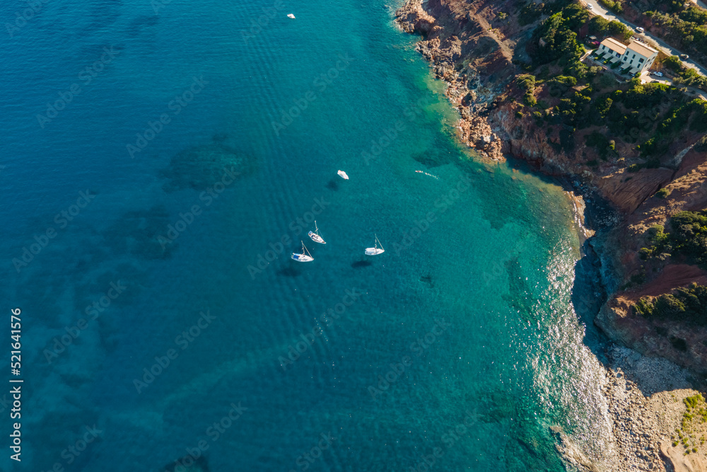Aerial view of the beautiful coastline with sailing boats near Rio, Elba Island, Tuscany, Italy. Aerial view of the beautiful coastline with sailing boats near Rio, Elba Island, Tuscany, Italy.