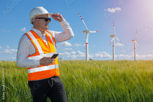 Man in front of wind turbin...