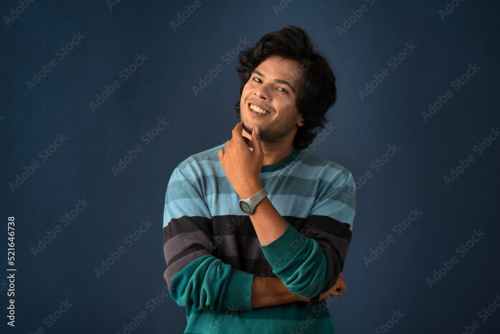 Portrait of a young man thinking on a dark background Portrait of a young man thinking on a dark background