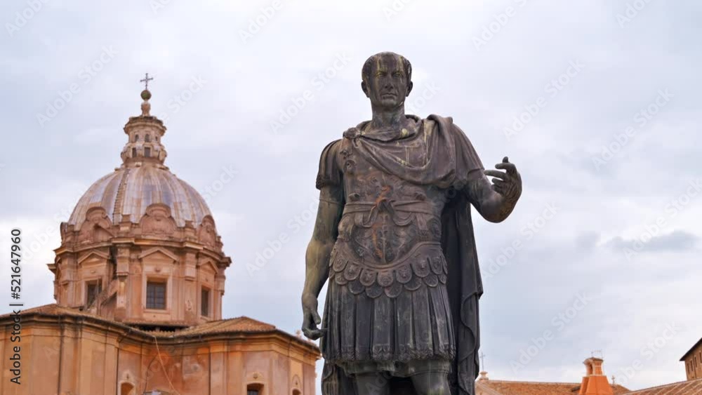 Statue of Julius Caesar located in the centre of Rome, Italy. Buildings on the background Statue of Julius Caesar located in the centre of Rome, Italy. Buildings on the background