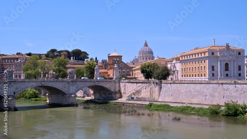 Timelapse view of the Tiber River in the center of Rome. Embankment street, ancient bridge and old buildings in the distance photo