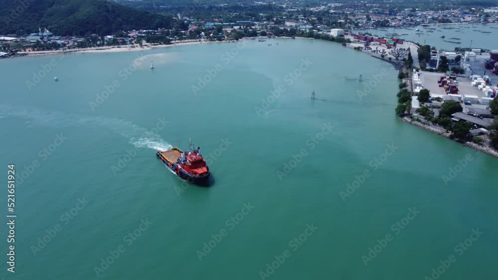 4K aerial view on top of a cargo ship carrying container and running for export cargo yard port to the international custom ocean. Concept of technology transportation, customs clearance. 4K aerial view on top of a cargo ship carrying container and running for export cargo yard port to the international custom ocean. Concept of technology transportation, customs clearance.