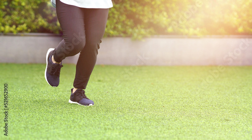 woman wearing sports shoes jogging run in the lawn