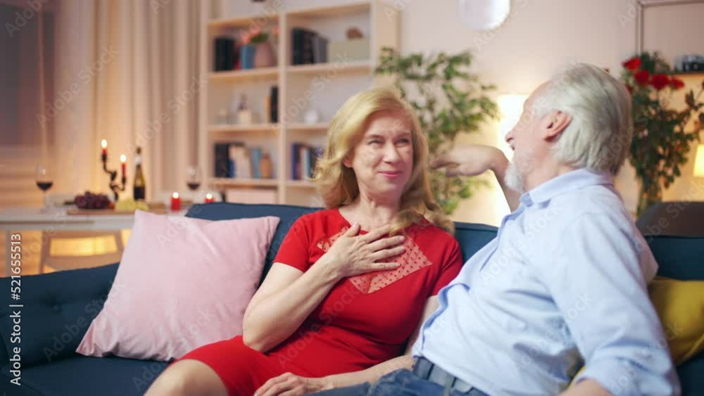 Middle-aged couple laughing together, making jokes, funny memories, emotions Middle-aged couple laughing together, making jokes, funny memories, emotions