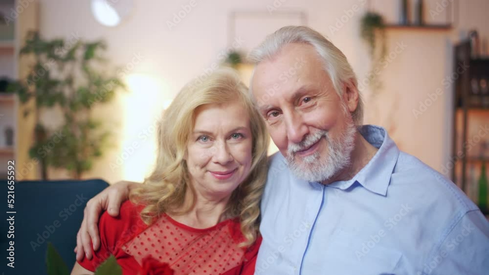 Smiling couple in their 50s on date, celebrating Valentine's day, romantic mood Smiling couple in their 50s on date, celebrating Valentine's day, romantic mood