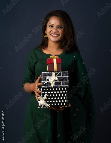 Portrait of young happy smiling woman or Girl holding gift box. © Dip Photography