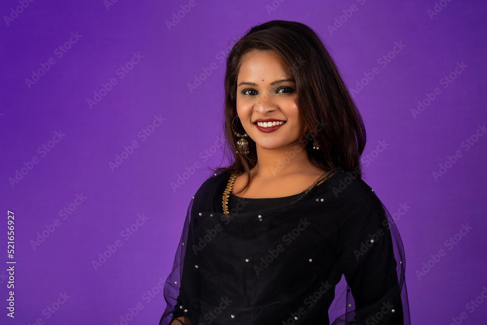 Portrait of a young girl or woman posing on purple background Portrait of a young girl or woman posing on purple background