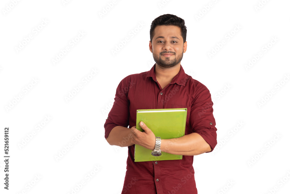 Young happy man holding and posing with the book on white background. Young happy man holding and posing with the book on white background.