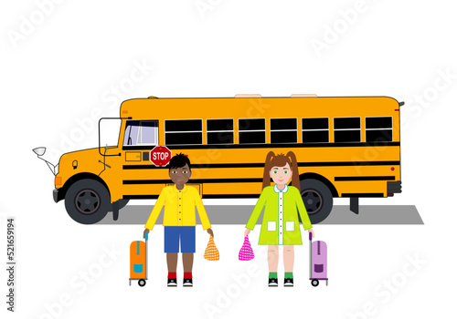 La vuelta al cole. Pareja de escolares portando una  bolsa de almuerzo y mochila de ruedas delante de un autobús o bus escolar amarillo photo