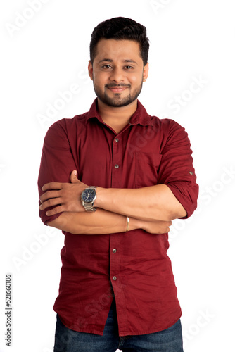 Portrait of a happy young man posing with arms crossed or hands folded on a white background