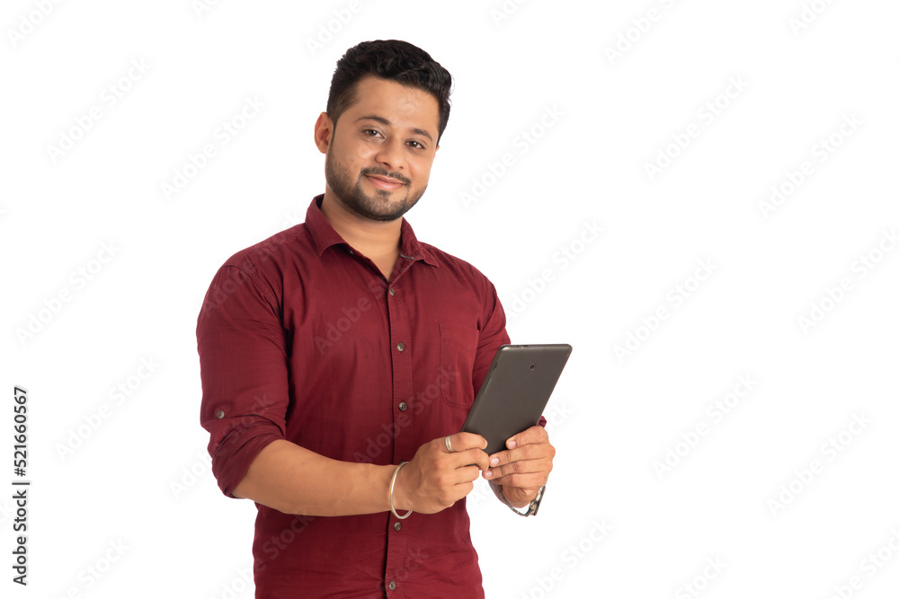 Young handsome man holding and using smartphone or mobile or tablet phone on a white background Young handsome man holding and using smartphone or mobile or tablet phone on a white background