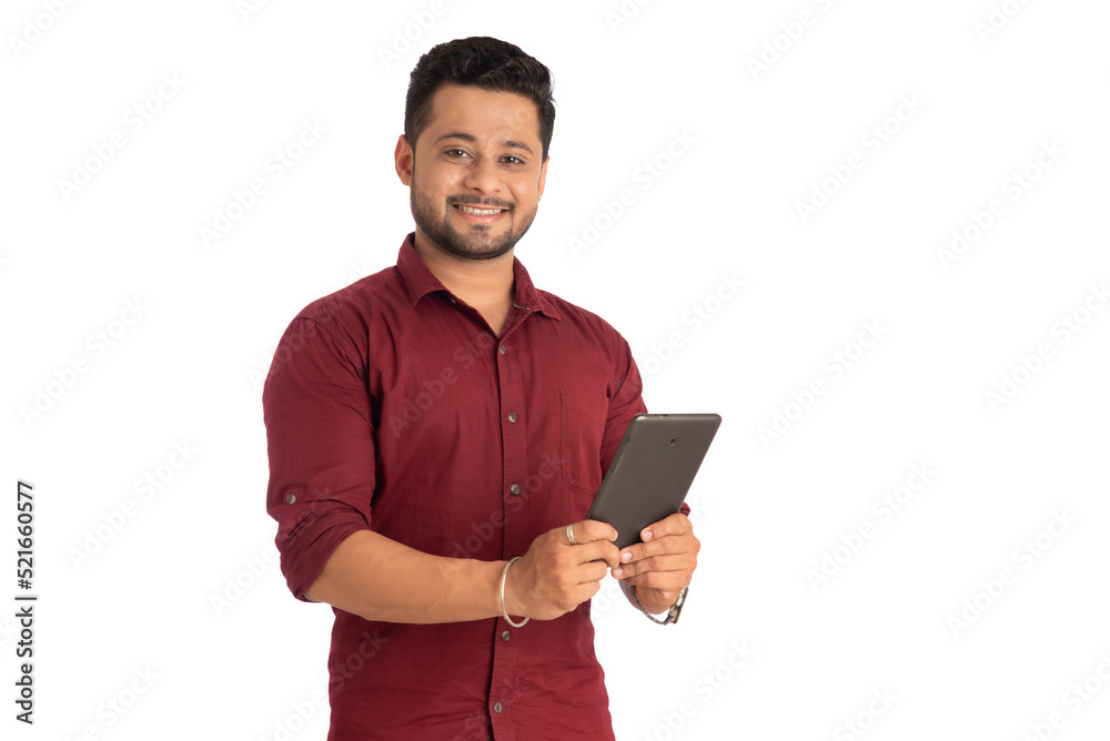 Young handsome man holding and using smartphone or mobile or tablet phone on a white background Young handsome man holding and using smartphone or mobile or tablet phone on a white background