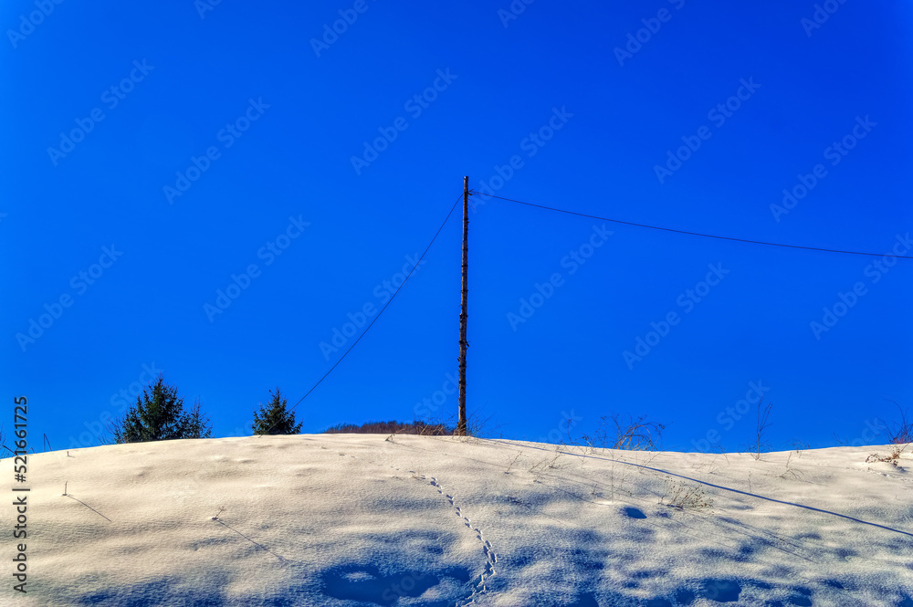 View over landscape covered with snow during sunny winter day. View over landscape covered with snow during sunny winter day.