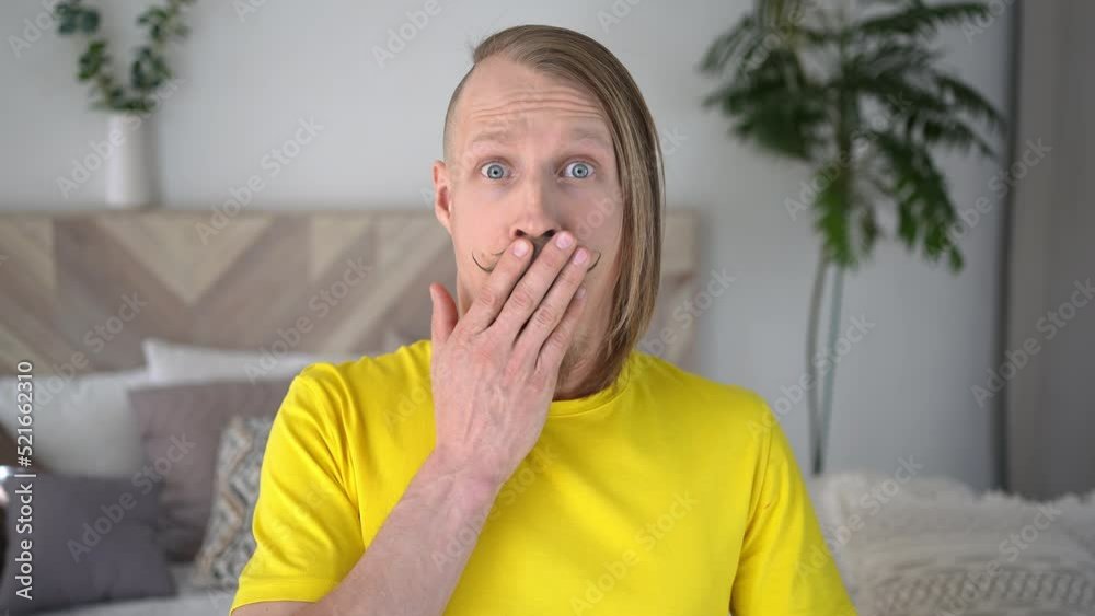 Concept of People emotion horror, fear, sensation, bad news. Studio portrait of funny young man shocked expression looking at camera. Handsome guy with mustache at home studio Concept of People emotion horror, fear, sensation, bad news. Studio portrait of funny young man shocked expression looking at camera. Handsome guy with mustache at home studio