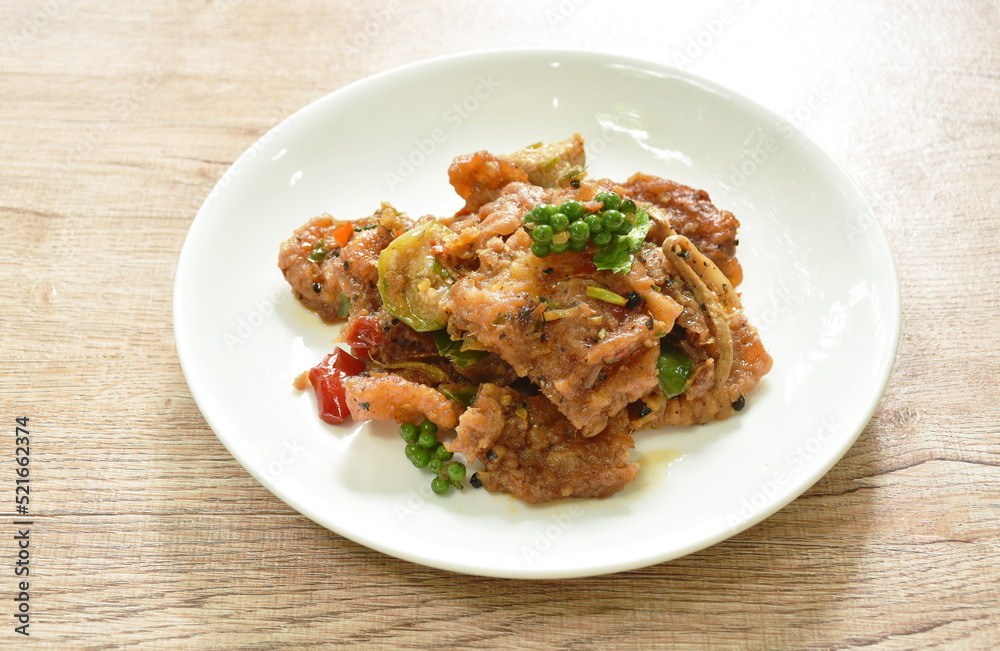 spicy deep fried slice bass fish with eggplant and pepper on plate spicy deep fried slice bass fish with eggplant and pepper on plate