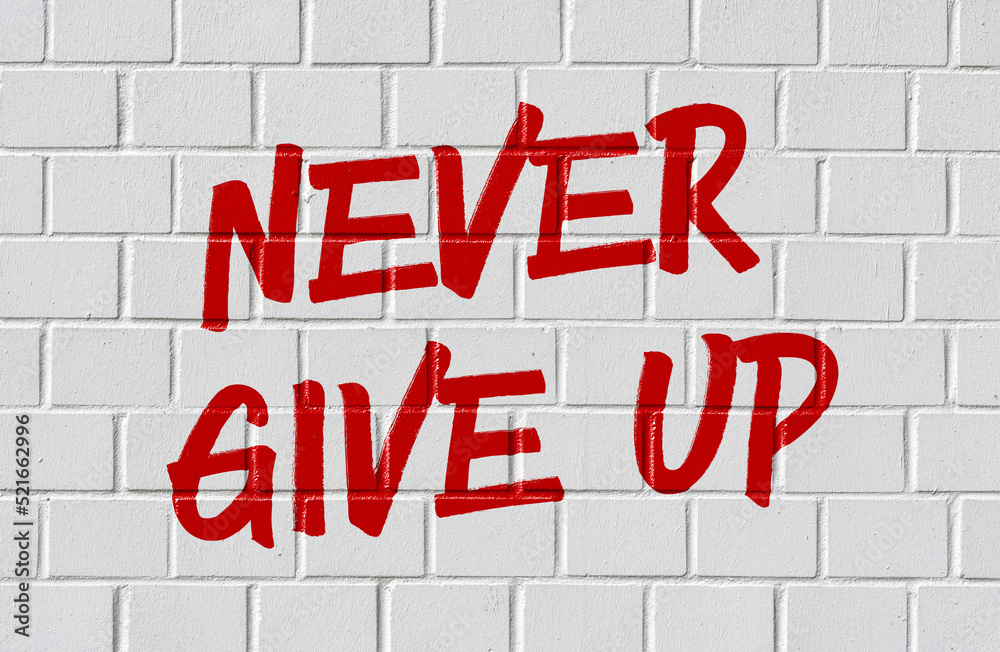 Graffiti on a brick wall - Never give up Graffiti on a brick wall - Never give up