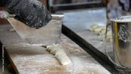 B Roll slow motion merchants grinding the bank to make deep-fried dough stick or Patongo
 for their customers' breakfast-Thailand street food-4k, Process05